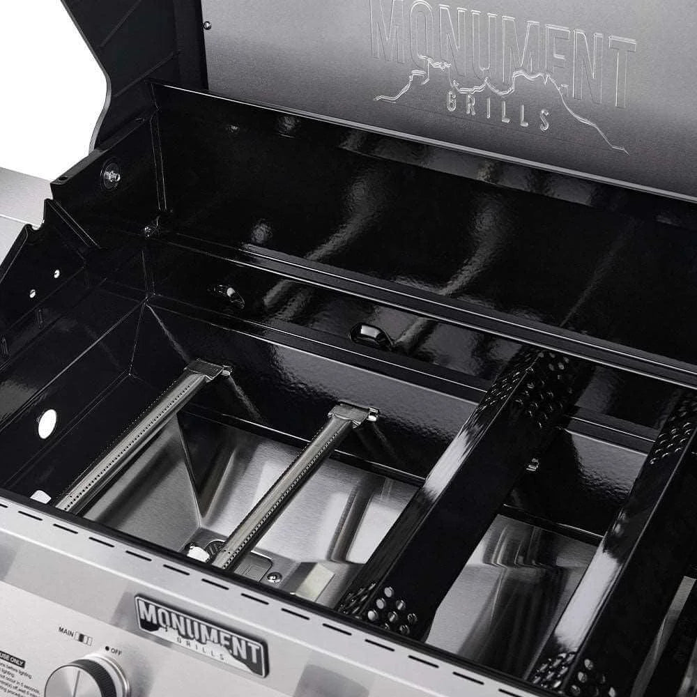 Close-up of a Monument Grills Denali 405 barbecue grill with open lid showing cooking area.