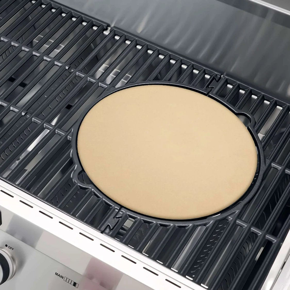 Uncooked pizza dough on a grill pan inside a Monument Grills Denali 605 Pro