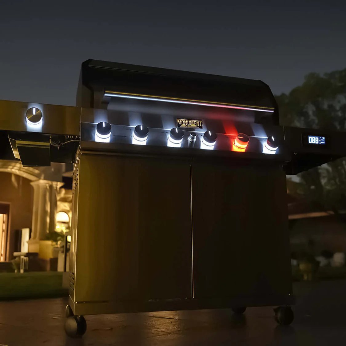Monument Grills Denali 605 Pro - Grill with digital display and control panel on a patio at night