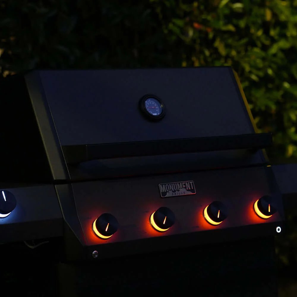 Monument Grills Eminence 425 with glowing burners in the dark
