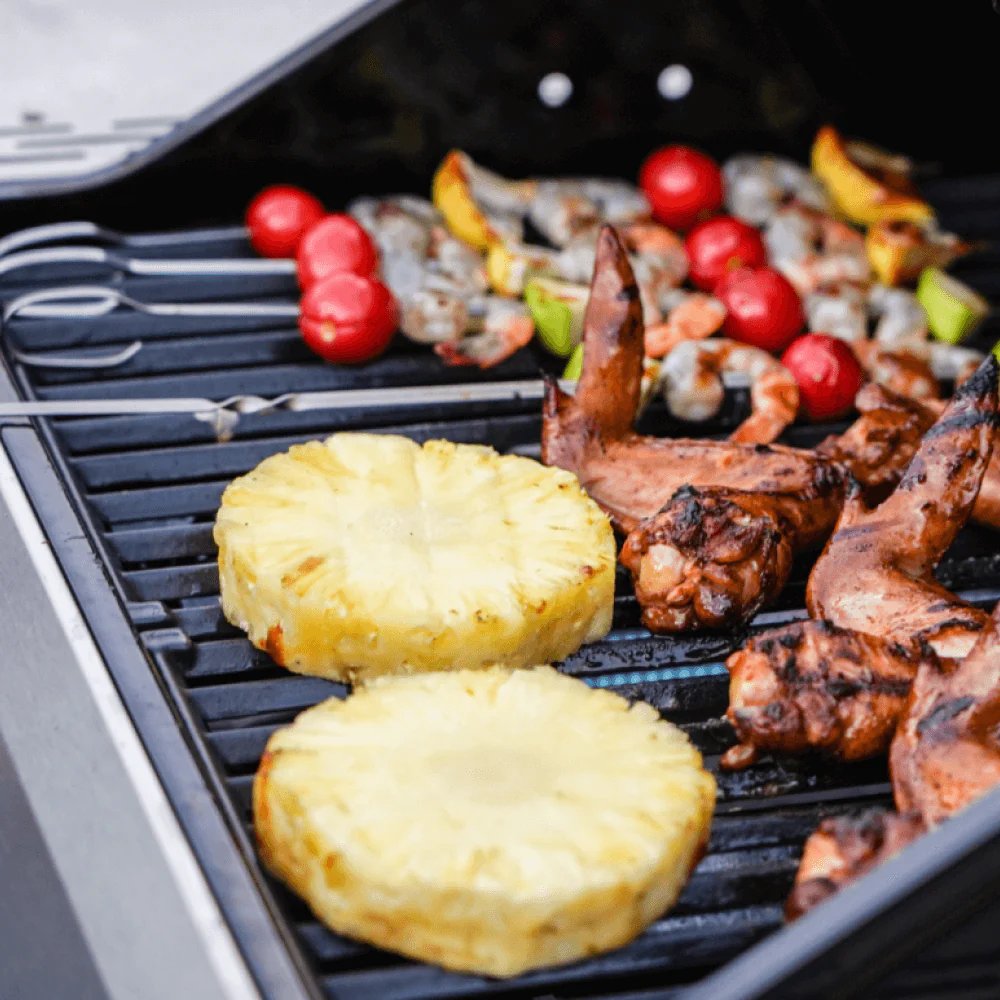 Grilled pineapple slices and seafood on a Monument Grills Mesa 200S