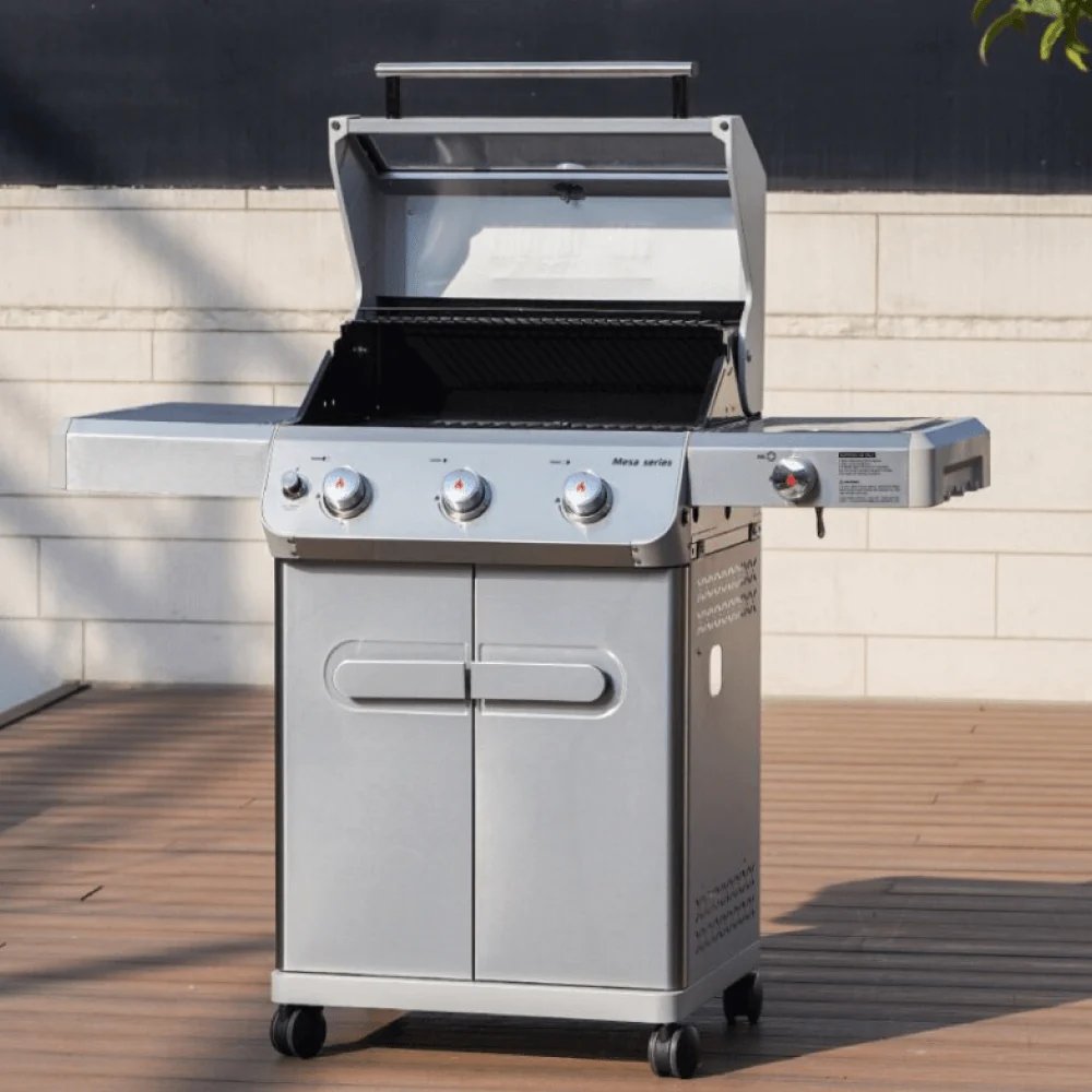 Stainless steel Monument Grills Mesa 305 placed on a wooden deck with a neutral background.