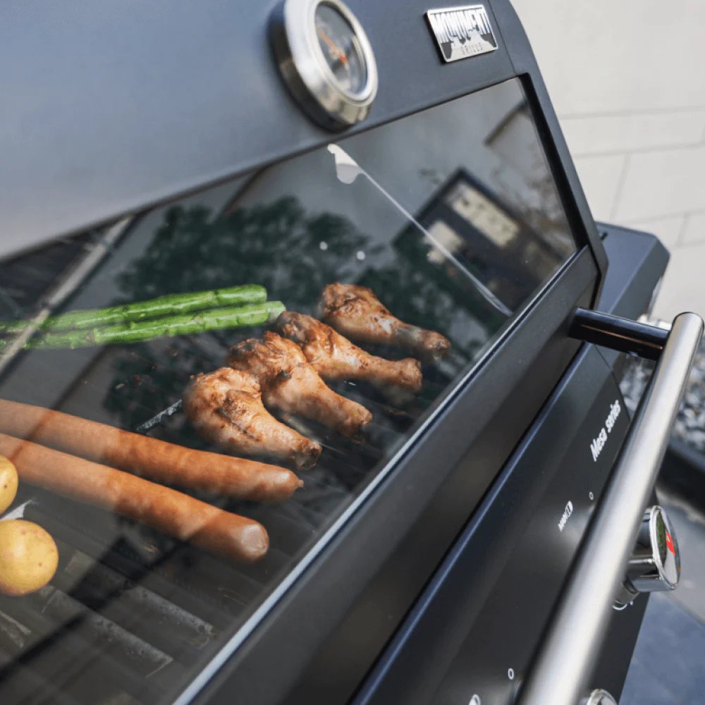 Monument Grills Mesa 325 - food being cooked, including chicken legs and vegetables.