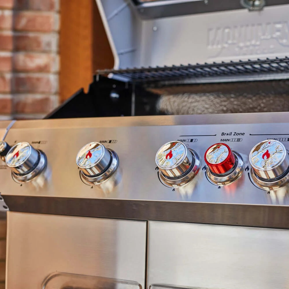 Close-up of a stainless steel Monument Grills Mesa 415BZ with control knobs on an outdoor setting.