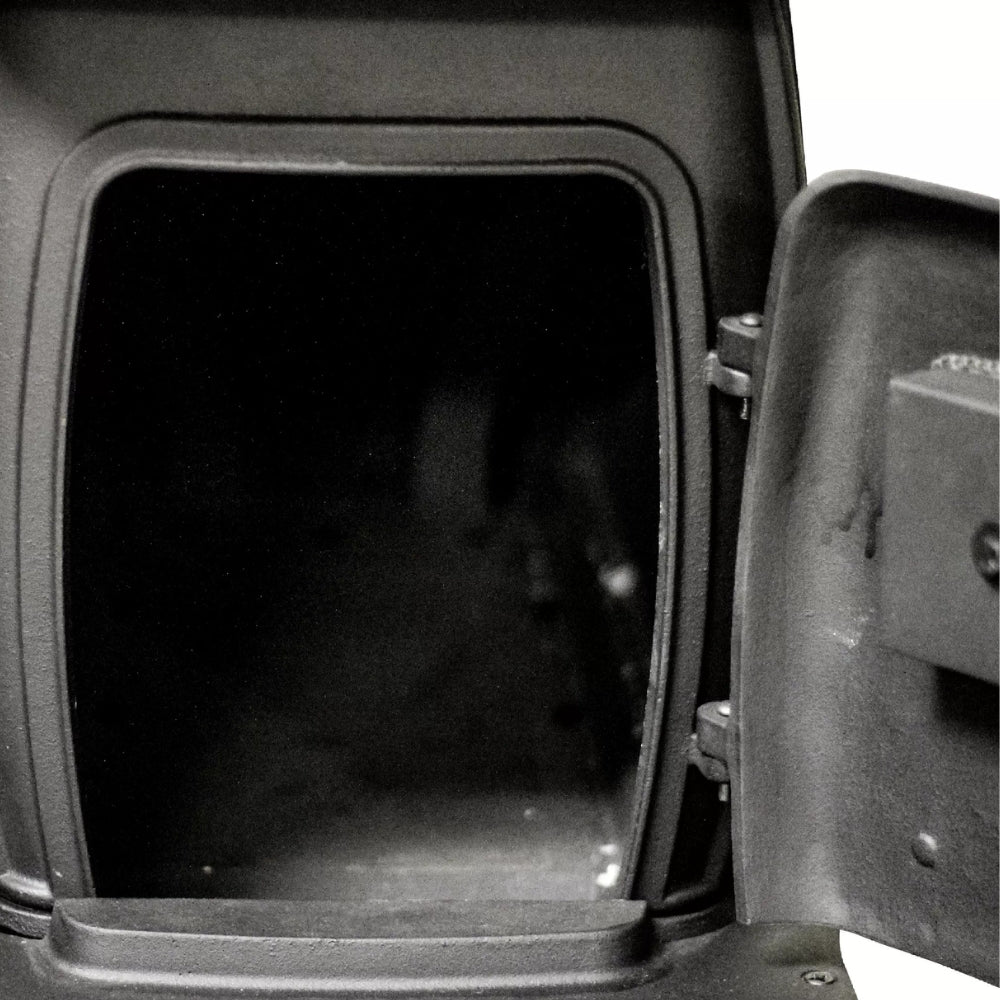 US Stove US1261E-KIT Cast Iron Log Wood Stove and Dual Side Table Set - Cat inside a black pet carrier with a dark interior