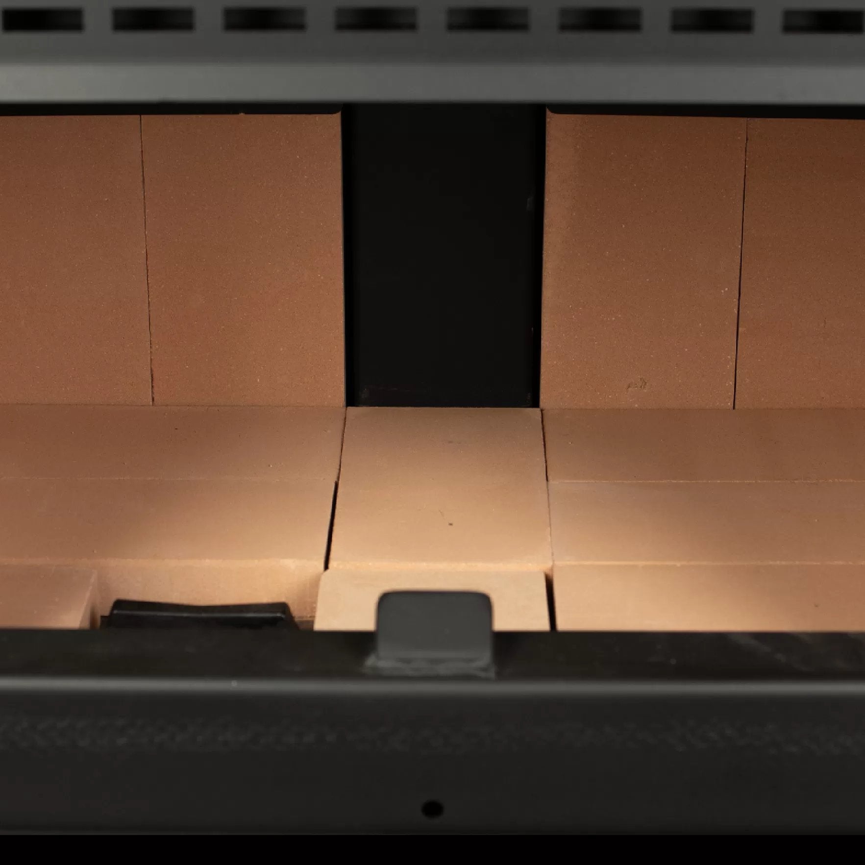 Vogelzang 2,500 Sq. Ft. Pedestal Wood Stove VG2520-P - Close-up of a cardboard box with a black object inside