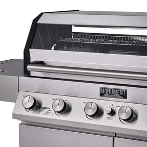 Stainless steel grill with control knobs and 'Monument Grills Denali 605' branding.