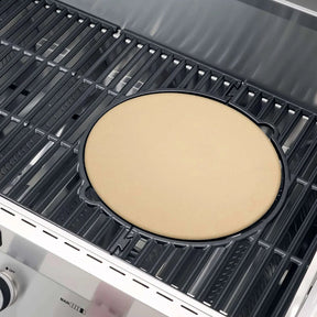 Uncooked pizza dough on a grill pan inside a Monument Grills Denali 605 Pro