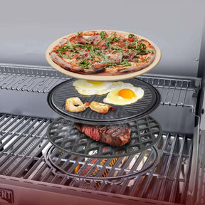 Multi-tiered grill pan with pizza, eggs, and meat on a Monument Grills Denali 605 Pro
