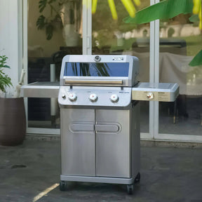 Stainless steel outdoor Monument Grills Mesa 305 on a patio with plants and furniture in the background