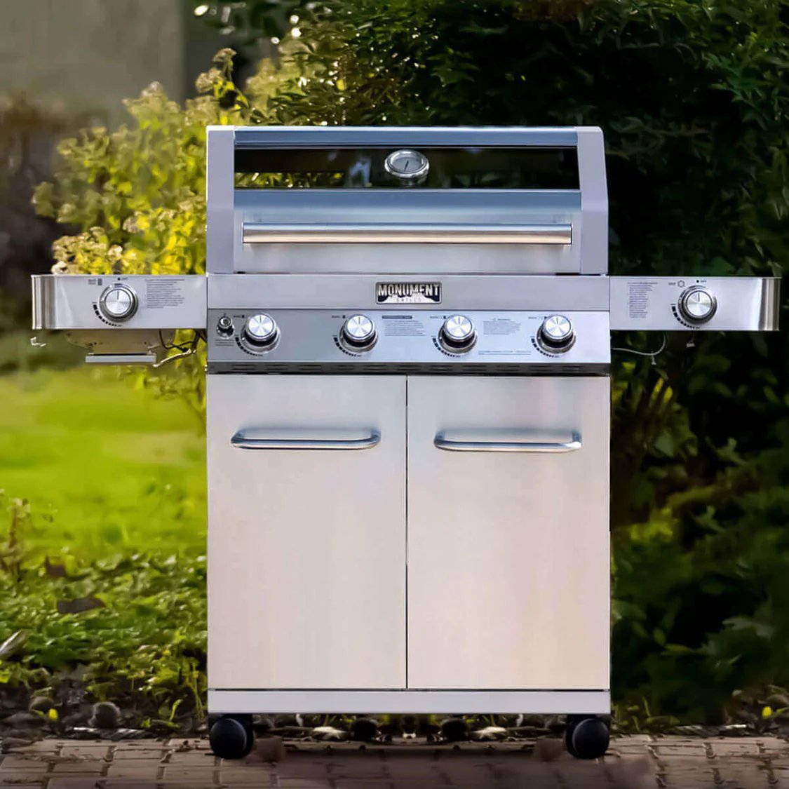 Stainless steel barbecue grill with outdoor setting