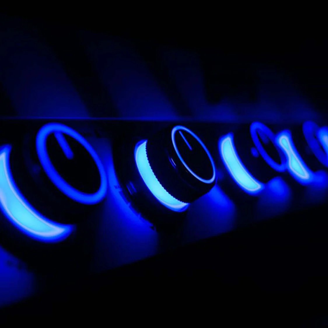 Glowing blue circular objects on a dark background