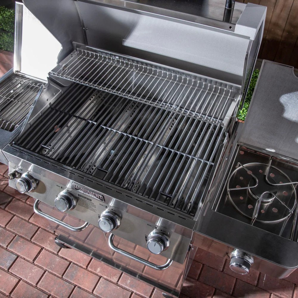 Stainless steel grill with multiple burners on a brick patio
