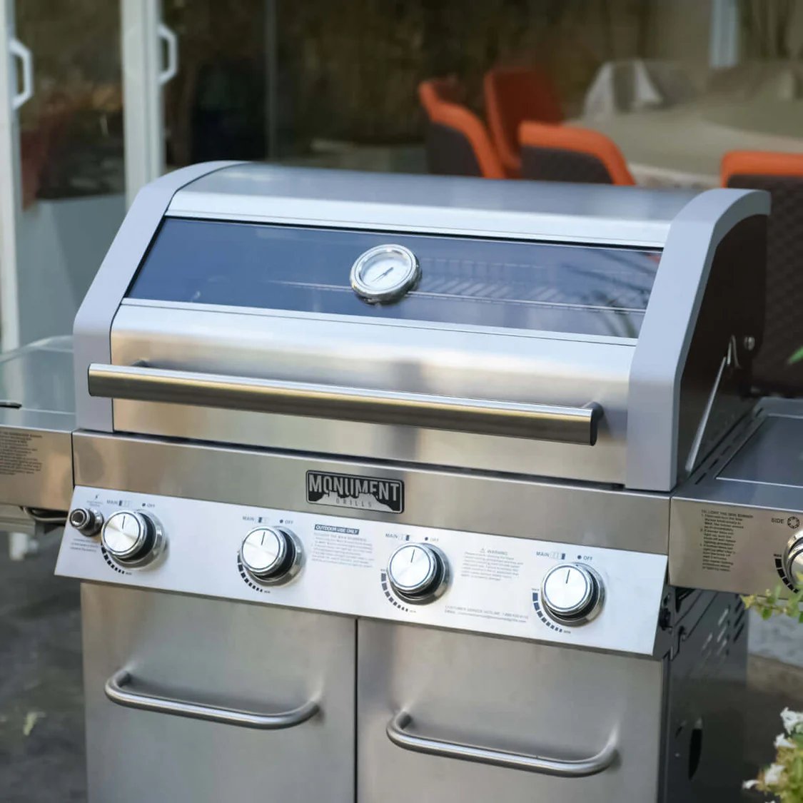 Stainless steel grill with brand logo on a patio background