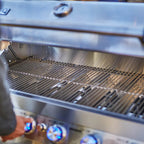 Close-up of a stainless steel grill with visible brand name