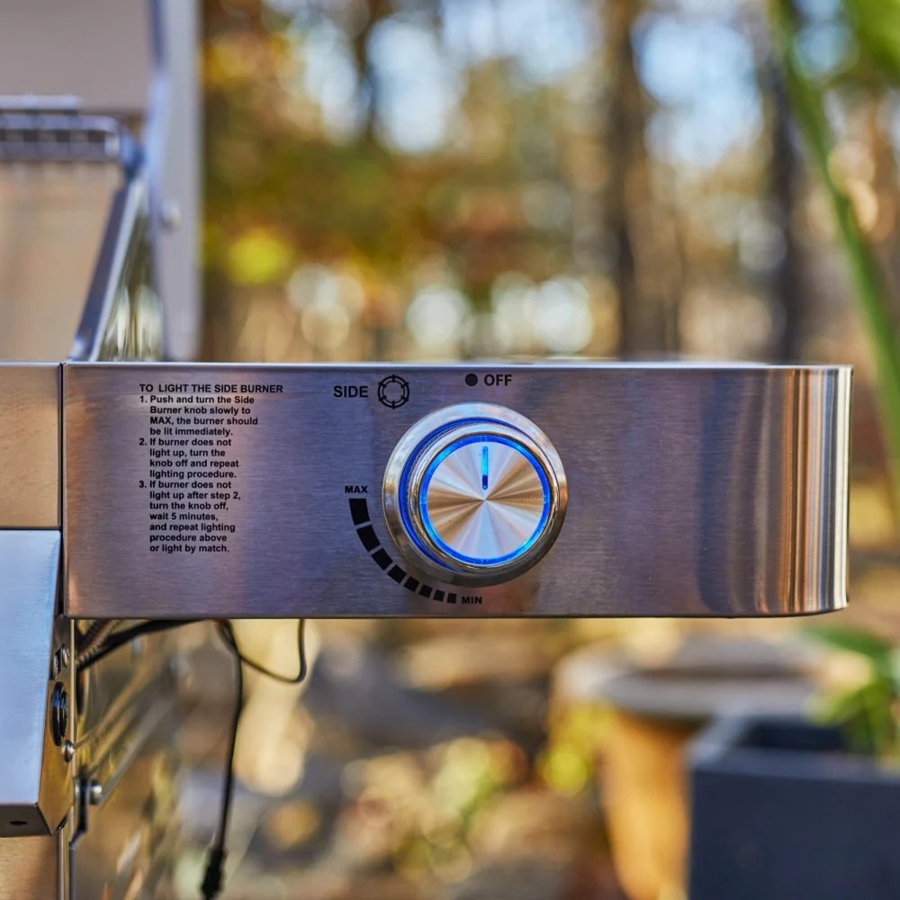 Control panel of a grill with a blurred outdoor background