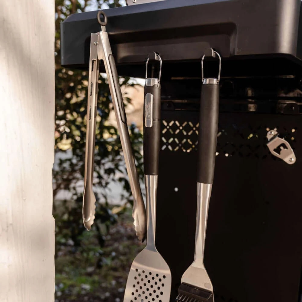 Set of barbecue tools hanging on a grill