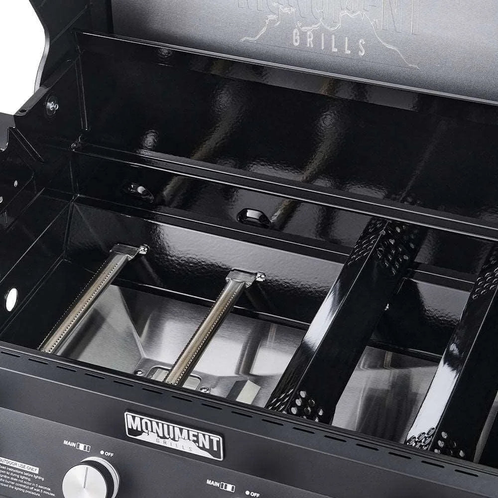 Close-up of a black barbecue grill with 'Monument' branding.