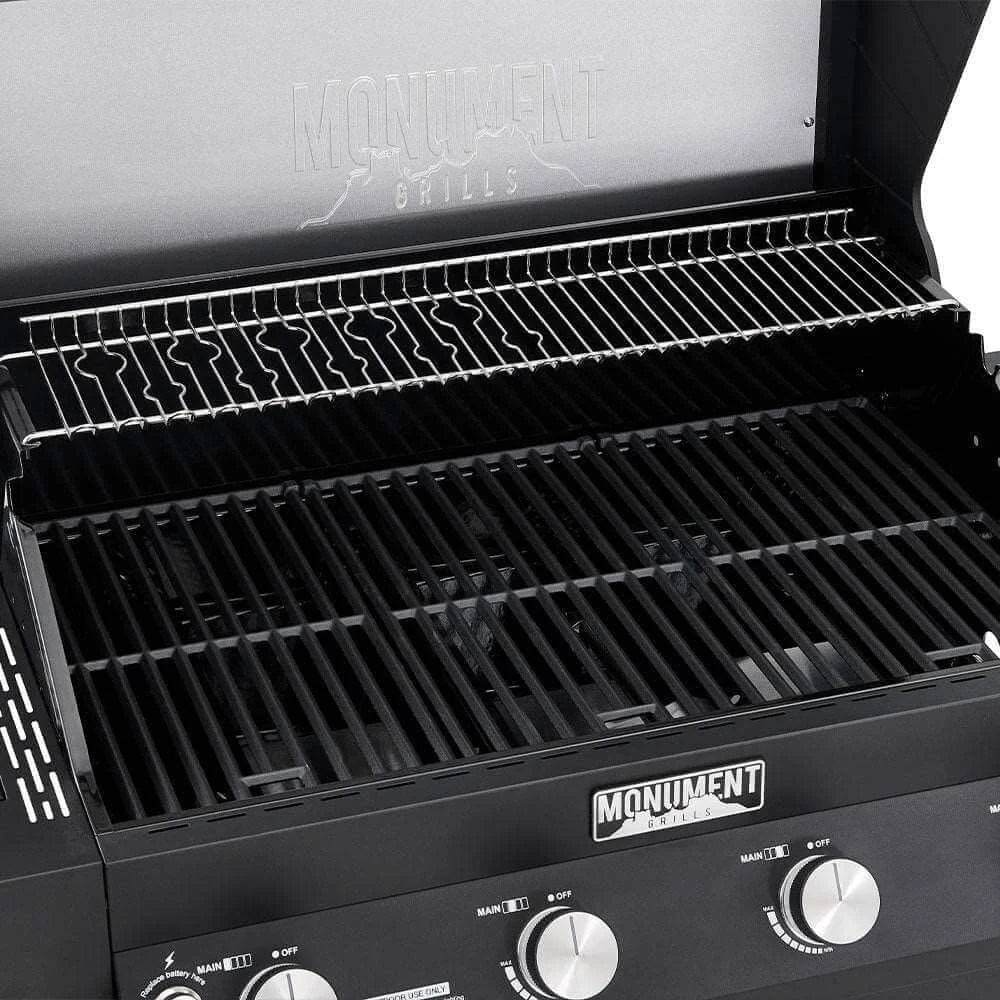 Close-up of a black grill with visible branding, showing grates and control knobs.