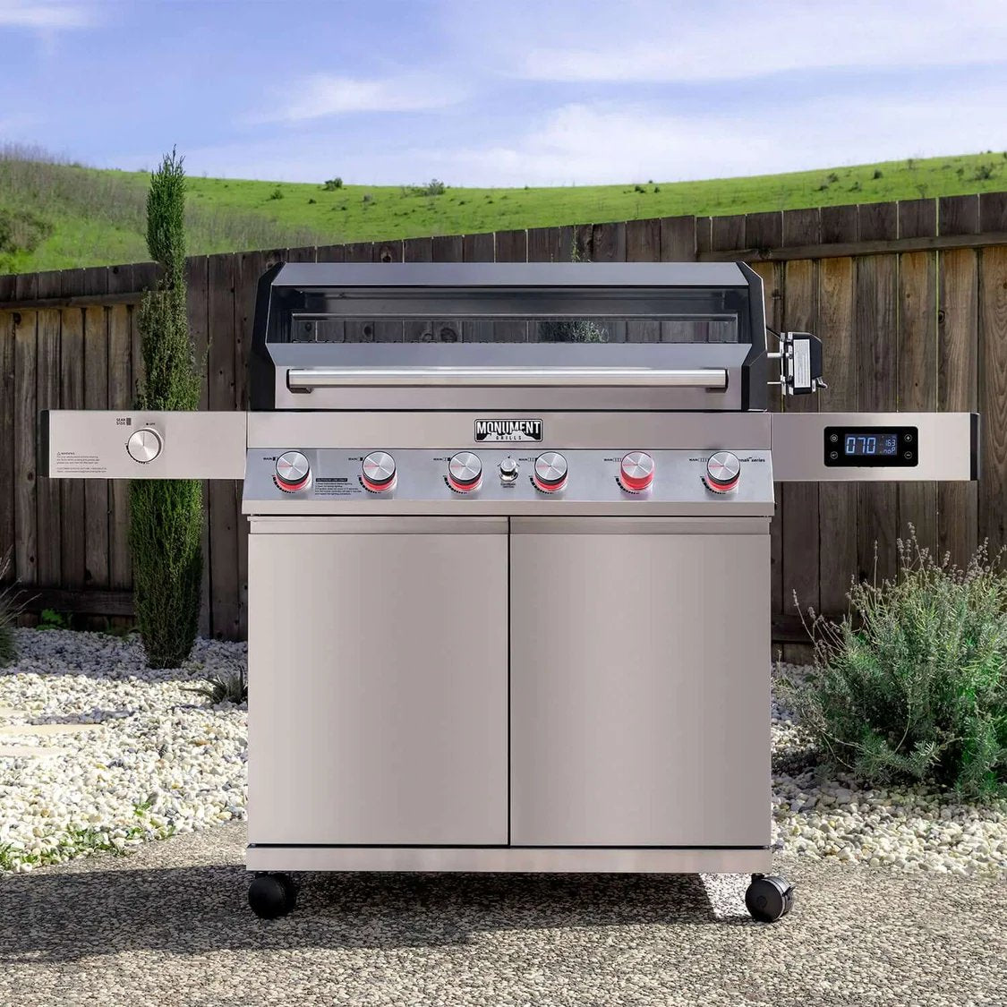 Stainless steel grill with digital display in an outdoor setting