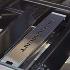 Close-up of a car's interior with 'Monument' branding on a metallic panel.