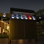 Outdoor grill with digital display and lights on a patio at night
