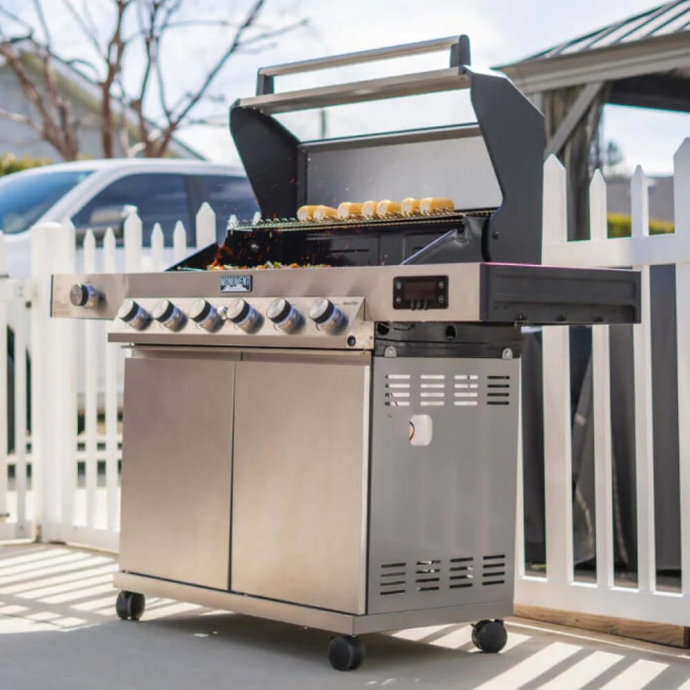 Stainless steel grill with food on a patio