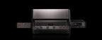 Black and silver grill with visible brand logo on a black background