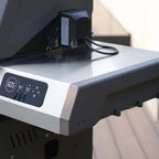 Close-up of a electronic device with a digital display on a blurred background