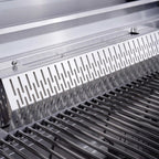 Close-up of a grill with a metallic cover and visible grates.
