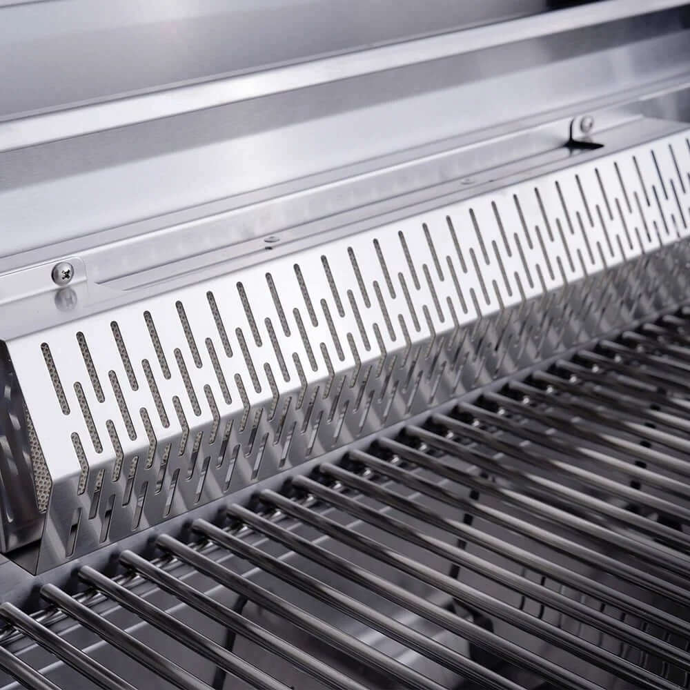 Close-up of a grill with a metallic cover and visible grates.