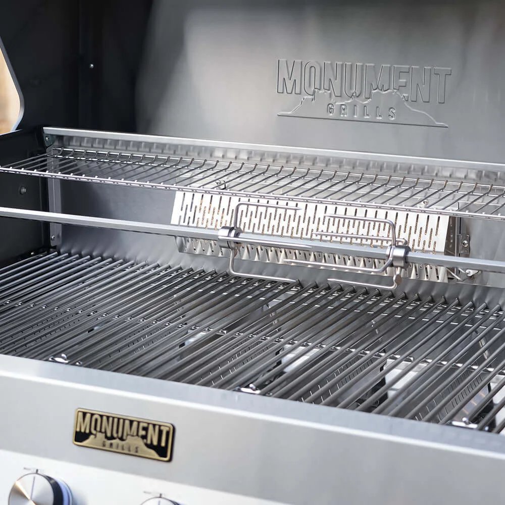 Close-up of a grill with 'Monument Grills' branding on the lid and side.