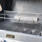 Close-up of a grill with 'Monument Grills' branding on the lid and side.