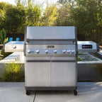Stainless steel grill with brand logo on a patio with greenery