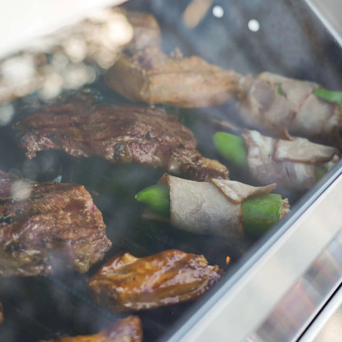 Close-up of grilled meat and vegetables on a grill