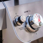 Close-up of a gas grill control panel with electronic ignition and brand logo.