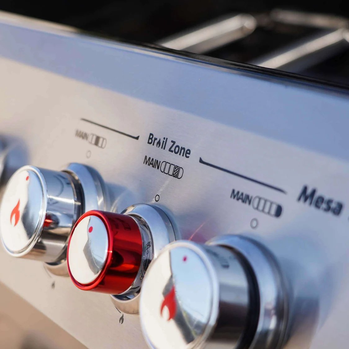 Control knobs on a stove with 'Brill Zone' and 'Mesa' branding.