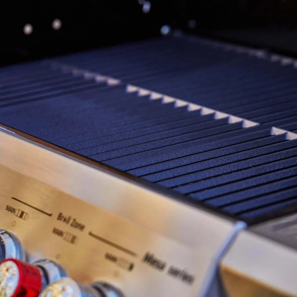 Close-up of a grill with a control panel and various knobs.