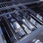 Close-up of a grill's interior with metal components and branding.
