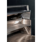 Stainless steel grill with open lid on a black background