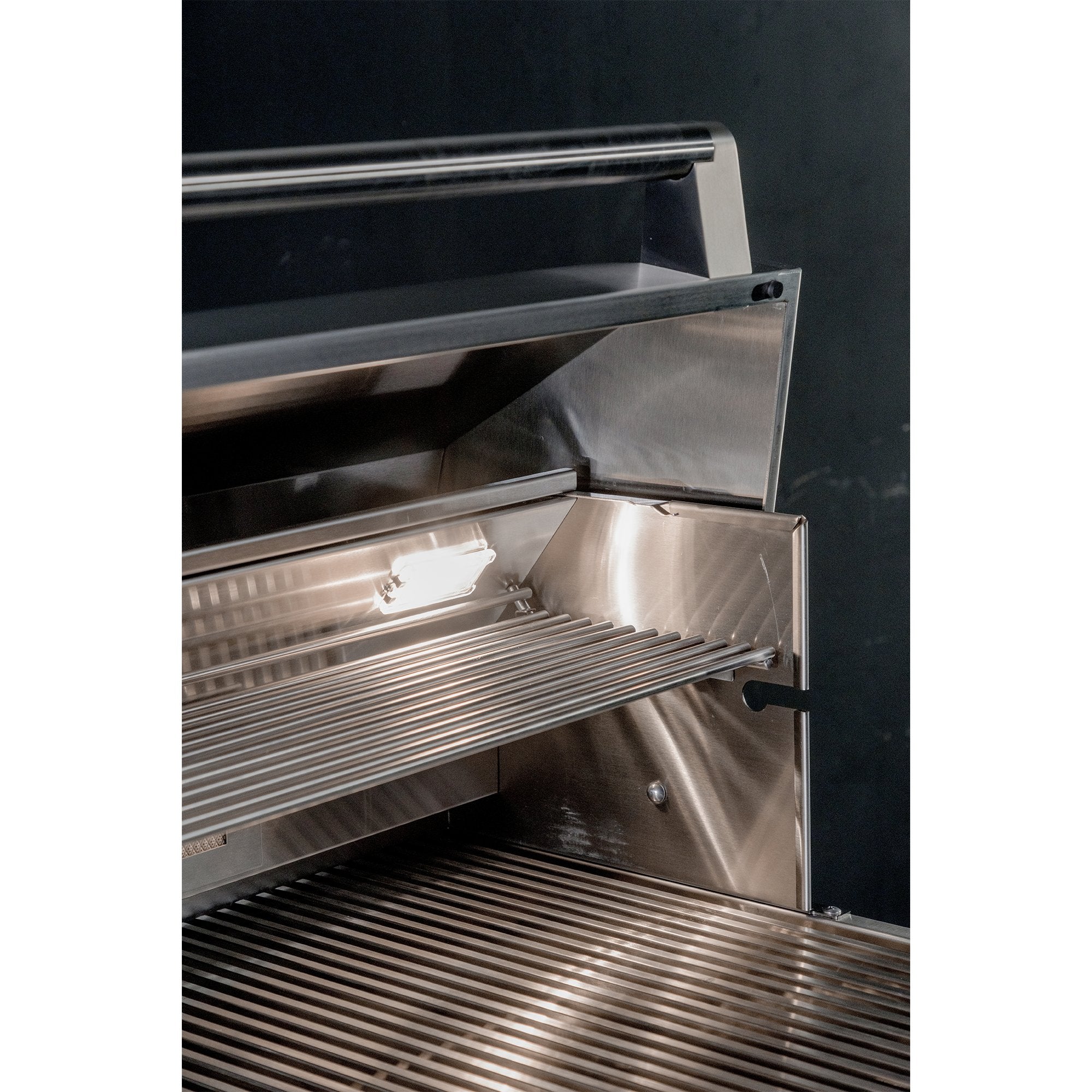 Stainless steel grill with open lid on a black background