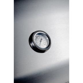 Stainless steel appliance with a round temperature gauge on a white background