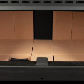 Vogelzang 2,500 Sq. Ft. Pedestal Wood Stove VG2520-P - Close-up of a cardboard box with a black object inside