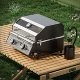 Monument Grills G22 tabletop propane gas grill with stainless steel finish, portable design, and 15,000 BTU burners