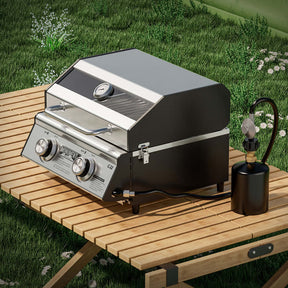Monument Grills G22 tabletop propane gas grill with stainless steel finish, portable design, and 15,000 BTU burners