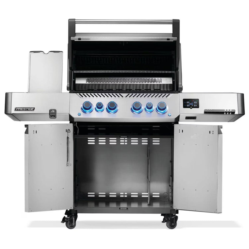 Stainless steel gas grill with blue LED knobs, open lid, side shelves, and storage cabinet