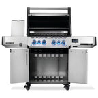 Stainless steel gas grill with blue LED knobs, open lid, side shelves, and storage cabinet