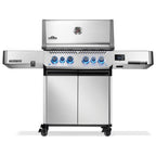 Stainless steel Napoleon Prestige gas grill with blue-lit knobs and digital display