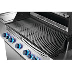Stainless steel gas grill with blue-lit control knobs and wavy grates for outdoor BBQ cooking