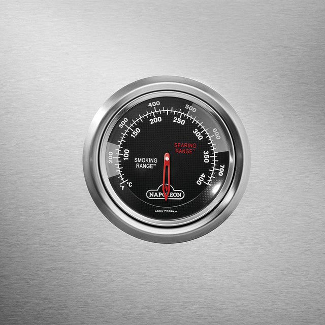 Napoleon BBQ grill thermometer showing smoking and searing ranges on stainless steel surface